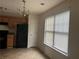 Functional kitchen with wood cabinets, black appliances, tile floor and lots of light from the window at 312 Lauren Dr, Fairburn, GA 30213