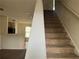 View of carpeted staircase with white risers near the kitchen and dining room at 312 Lauren Dr, Fairburn, GA 30213