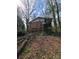 View of the rear of a single Gathering home in a natural setting at 4028 William Mary Ct, Decatur, GA 30034