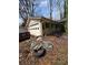 View of the home's garage and side exterior, surrounded by natural landscaping at 4028 William Mary Ct, Decatur, GA 30034