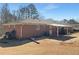 The backyard of this brick house offers a covered patio and a fenced-in yard providing privacy and space at 6691 Birch Dr, Winston, GA 30187
