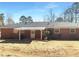 The backyard of this brick house boasts a covered patio, offering a perfect spot for relaxation and outdoor enjoyment at 6691 Birch Dr, Winston, GA 30187