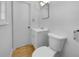 A small half-bathroom with a modern toilet and sink, and a simple mirror at 6691 Birch Dr, Winston, GA 30187