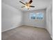 A bright, empty bedroom features large windows, neutral carpet, and a ceiling fan at 6691 Birch Dr, Winston, GA 30187