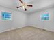 Bright bedroom with two windows and ceiling fan, offering plenty of natural light and air circulation at 6691 Birch Dr, Winston, GA 30187