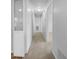 Bright hallway with carpet floors, lighting and multiple doors that offers easy access to different rooms at 6691 Birch Dr, Winston, GA 30187
