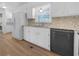 Bright kitchen featuring white cabinets, stainless steel appliances, and a window for natural light at 6691 Birch Dr, Winston, GA 30187