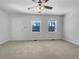 An empty living room with two windows that provide natural light, creating a bright atmosphere at 6691 Birch Dr, Winston, GA 30187
