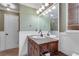Well-lit bathroom with a rustic wood vanity and decorative fixtures at 2825 Parnell Springs Ct, Cumming, GA 30040