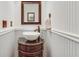 Elegant powder room with a vessel sink and decorative mirror at 2825 Parnell Springs Ct, Cumming, GA 30040