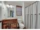 Charming bathroom with a rustic wood vanity, beadboard walls, and a neutral-toned shower curtain at 2825 Parnell Springs Ct, Cumming, GA 30040