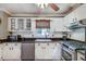 Bright kitchen featuring white cabinets, tile backsplash, and stainless steel appliances at 2825 Parnell Springs Ct, Cumming, GA 30040