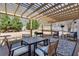 Outdoor dining area with a pergola providing shade, perfect for entertaining guests at 2825 Parnell Springs Ct, Cumming, GA 30040