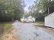 Back exterior view of home with an outdoor deck in a wooded area at 8083 Highway 166, Douglasville, GA 30135