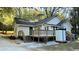 Rear exterior view of home featuring a spacious wooden deck and stairs leading to the yard at 8083 Highway 166, Douglasville, GA 30135