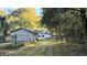 View of the backyard with shed and surrounding woodlands at 8083 Highway 166, Douglasville, GA 30135