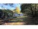View of the backyard with shed and surrounding woodlands at 8083 Highway 166, Douglasville, GA 30135