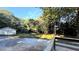 View of backyard and detached garage with gravel driveway in a wooded area at 8083 Highway 166, Douglasville, GA 30135