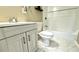 Updated bathroom featuring stylish vanity, toilet, and a bathtub with white tile surround at 8083 Highway 166, Douglasville, GA 30135