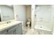 Modern bathroom featuring a sleek vanity, toilet, and stand-up shower with white tile at 8083 Highway 166, Douglasville, GA 30135