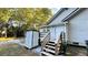 Exterior of home featuring wood stairs and a portable storage shed at 8083 Highway 166, Douglasville, GA 30135