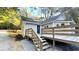 Back exterior of home showing a wooden deck, stairs, and a blue door at 8083 Highway 166, Douglasville, GA 30135
