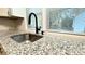 Close up of kitchen counter with granite countertops and large sink at 8083 Highway 166, Douglasville, GA 30135