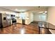 Bright kitchen features stainless steel appliances, white cabinetry and hardwood floors at 8083 Highway 166, Douglasville, GA 30135
