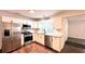 Bright kitchen with stainless steel appliances and white cabinets at 8083 Highway 166, Douglasville, GA 30135