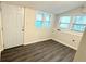 Bright room with multiple windows, vinyl floors, and a white door at 8083 Highway 166, Douglasville, GA 30135