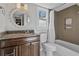 Charming bathroom with decorative mirror, granite countertop, and shower with unique tiling at 1835 Tree Top Way, Marietta, GA 30062