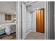 A closet featuring wire and wood shelving stands near a cozy bedroom with a bed and a bamboo art piece at 1835 Tree Top Way, Marietta, GA 30062