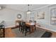 Dining room with natural light, hardwood floors, and a table with black chairs at 1835 Tree Top Way, Marietta, GA 30062