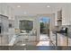 Cozy breakfast nook with a built-in bench and a view of the outdoor deck from the bright, updated kitchen at 1835 Tree Top Way, Marietta, GA 30062