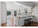 Bright and open kitchen featuring white cabinets, stainless steel appliances, and a breakfast bar with stools at 1835 Tree Top Way, Marietta, GA 30062