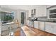 Updated kitchen with stainless steel appliances, white cabinetry, and a view of the outdoor deck at 1835 Tree Top Way, Marietta, GA 30062