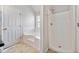 Well-lit bathroom showcases a walk-in shower and separate tub, designed for relaxation and functionality at 4768 Score Ct, Snellville, GA 30039