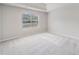Neutral bedroom with tray ceiling, large window, and plush carpeting at 4768 Score Ct, Snellville, GA 30039
