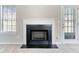 Close-up of the living room's fireplace with white mantle and black surround at 4768 Score Ct, Snellville, GA 30039