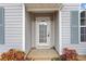 Up-close view of the front door with sidelights and decorative glass, framed by colorful landscaping at 4768 Score Ct, Snellville, GA 30039