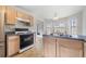 Kitchen with stainless appliances, laminate counters, and a view to backyard at 4768 Score Ct, Snellville, GA 30039