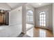 Open living room featuring neutral walls, hardwood and carpet flooring, and a large window at 4768 Score Ct, Snellville, GA 30039