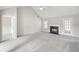 Spacious living room with vaulted ceiling, fireplace, and access to the exterior at 4768 Score Ct, Snellville, GA 30039