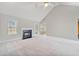 Open living room featuring fireplace, vaulted ceiling, and plenty of natural light at 4768 Score Ct, Snellville, GA 30039