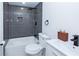 A modern bathroom features a sleek tub with shower and modern fixtures at 672 Quillian Ave, Decatur, GA 30032