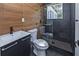 This modern bathroom features sleek wood look tile, a glass enclosed shower, and modern fixtures at 672 Quillian Ave, Decatur, GA 30032