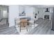 Open dining room featuring updated vinyl plank flooring and view into the kitchen at 672 Quillian Ave, Decatur, GA 30032
