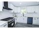 Bright kitchen featuring gray floors, white cabinets, subway tile backsplash, and stainless steel appliances at 672 Quillian Ave, Decatur, GA 30032