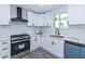 Bright kitchen featuring gray floors, white cabinets, subway tile backsplash, and stainless steel appliances at 672 Quillian Ave, Decatur, GA 30032