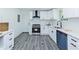 Bright kitchen featuring gray floors, white cabinets, subway tile backsplash, and stainless steel appliances at 672 Quillian Ave, Decatur, GA 30032